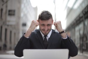 Man celebrating a win while betting online